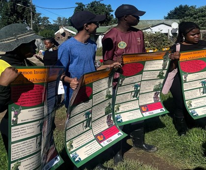 Members of the class teaching the kids about the different invasive species